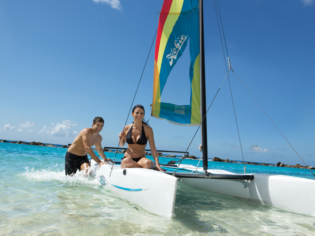 Couple on bright colored hobie cat