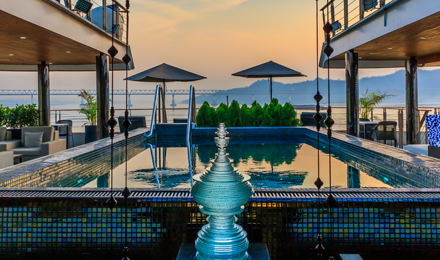 Scenic pool with a fountain and umbrellas in the background