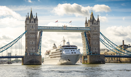 Silversea ship under the London bridge with bright blue skies