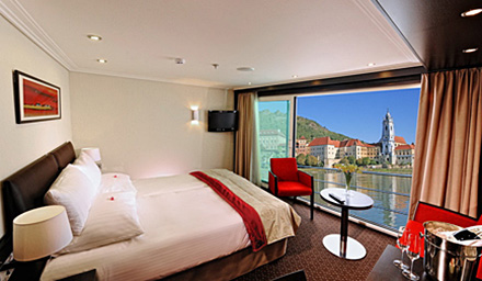 Avalon Waterways room accommodations including bed and panoramic balcony view