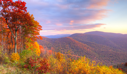 Bright Fall foliage, mountains and setting sun