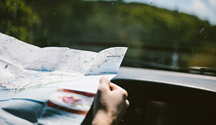 A man using a roadmap in the car