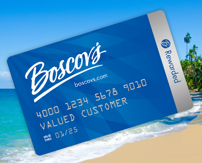 Boscov’s credit card angled on top of a tropical destination image with lush landscape and clear blue water