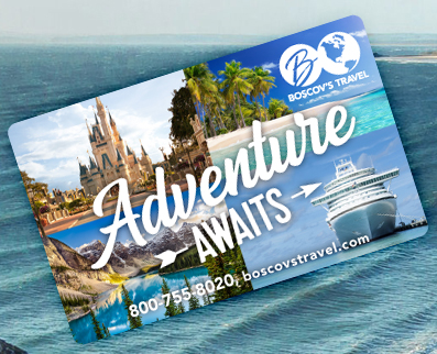 Boscov’s Travel gift card  angled on top of a beach with crashing waves