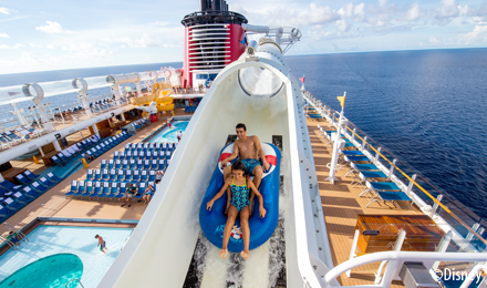 Kids riding a water slide on a Disney Cruise Line ship