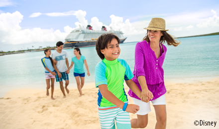 Cute family walking hand in hand on the beach in a tropical destination with a Disney Cruise Line ship in the background