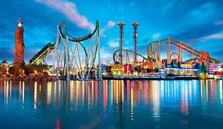Universal Orlando Resort theme park at night with roller coasters