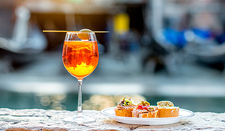 A glass of wine with mini pastries in Italy