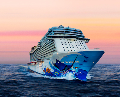 Norwegian Cruise Line ship in ocean at sunset