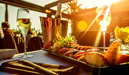 A bountiful lunch with wine and appetizers against a setting sun