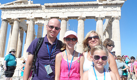 Cute family of 4 at ancient ruins in Greece