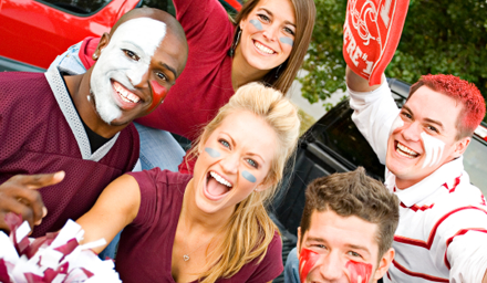 A group of young friends tailgating at a professional sports game